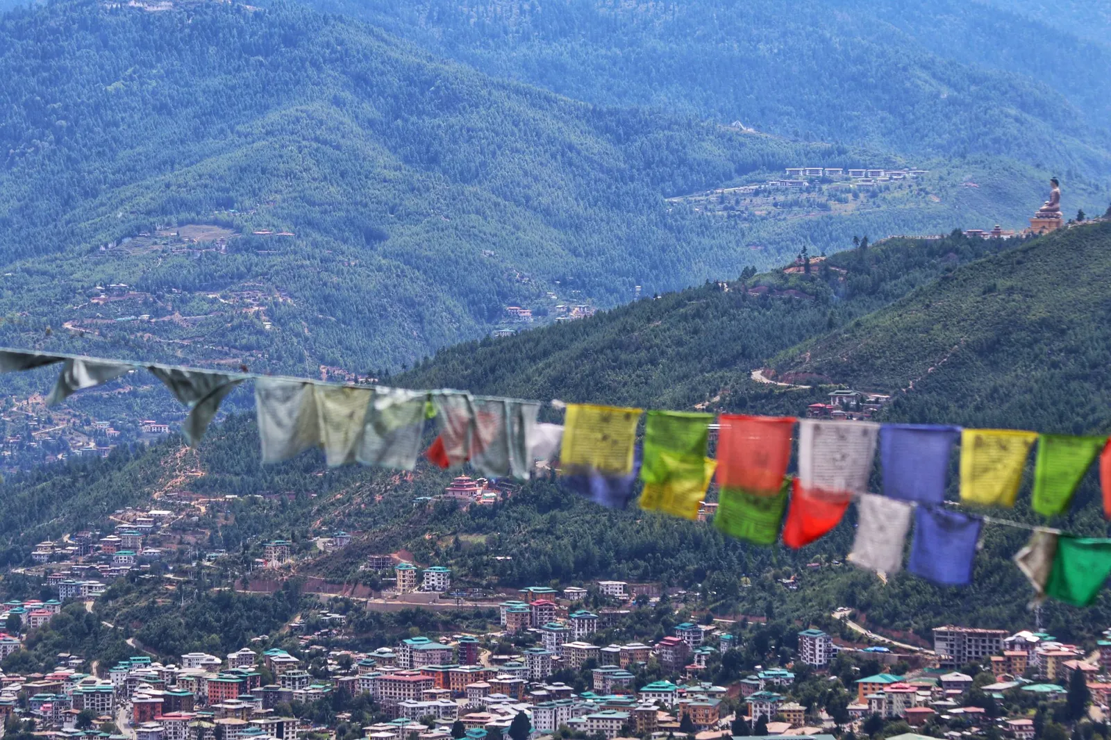 Prayer flags strung across a hillside above the town of Paro